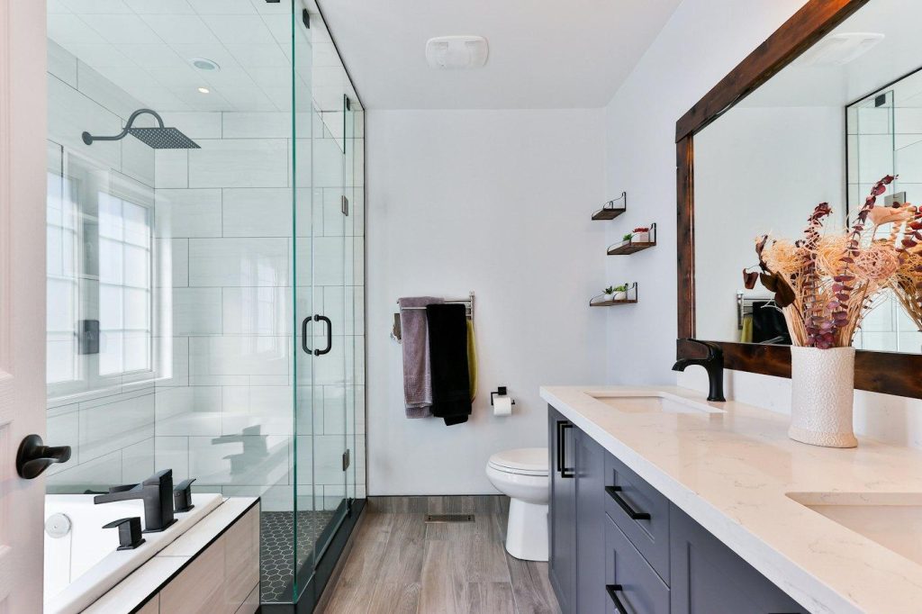Remodeled bathroom with a glass walk-in shower and a long vanity