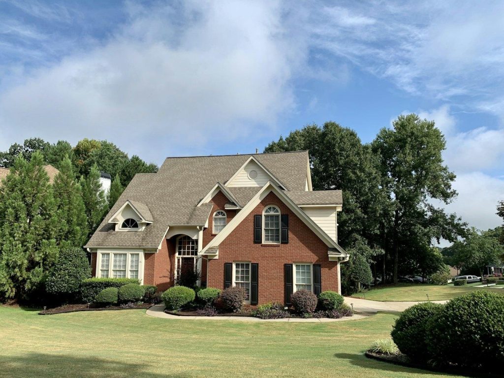 Brick two-story home with a green lawn