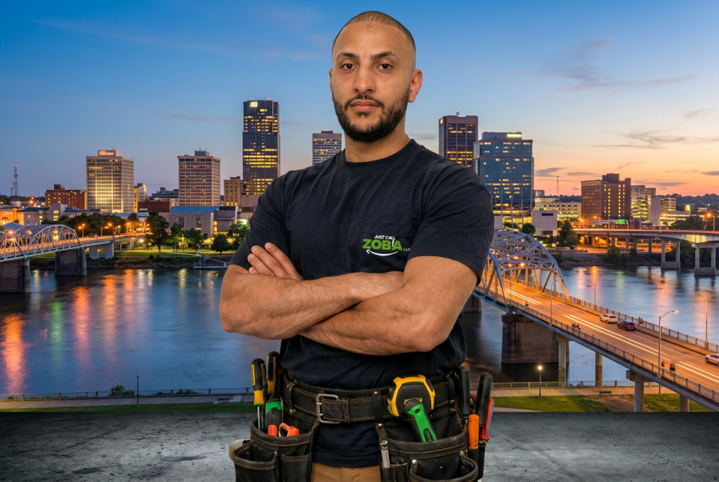 Zoba, owner of Just Call Zoba LLC, in front of the Little Rock skyline
